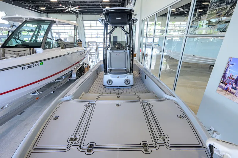 Slide: The Image of 2017 Yellowfin 24 Bay CE boat displayed in a showroom with sleek design and modern features. - 21