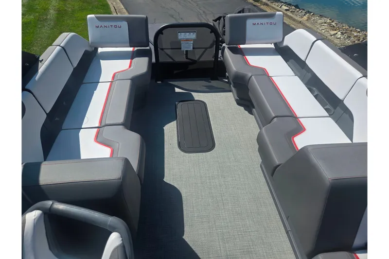Slide: The Image of 2024 Manitou Cruise pontoon boat interior with stylish seating and modern design. - 14