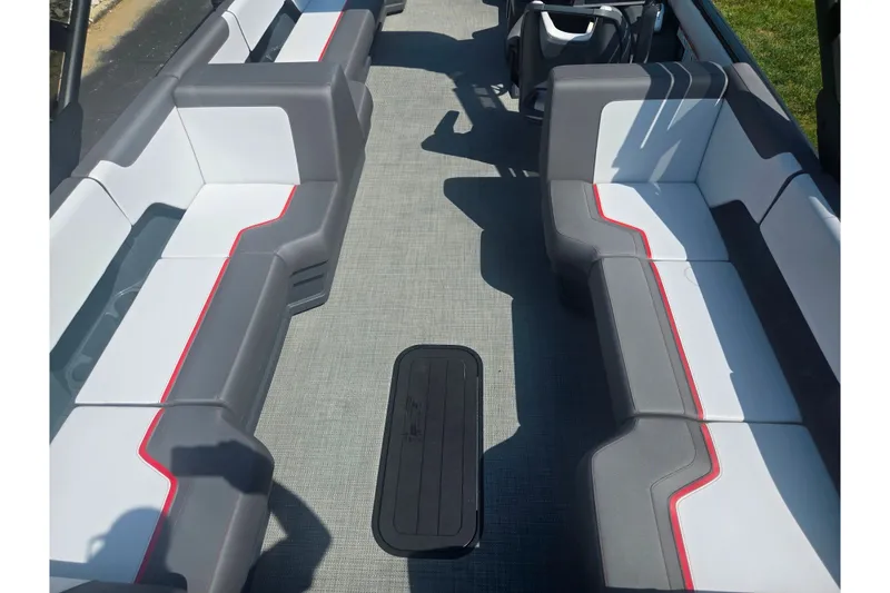 Slide: The Image of 2024 Manitou Cruise boat interior with gray and white seating, red accents, and spacious layout. - 16