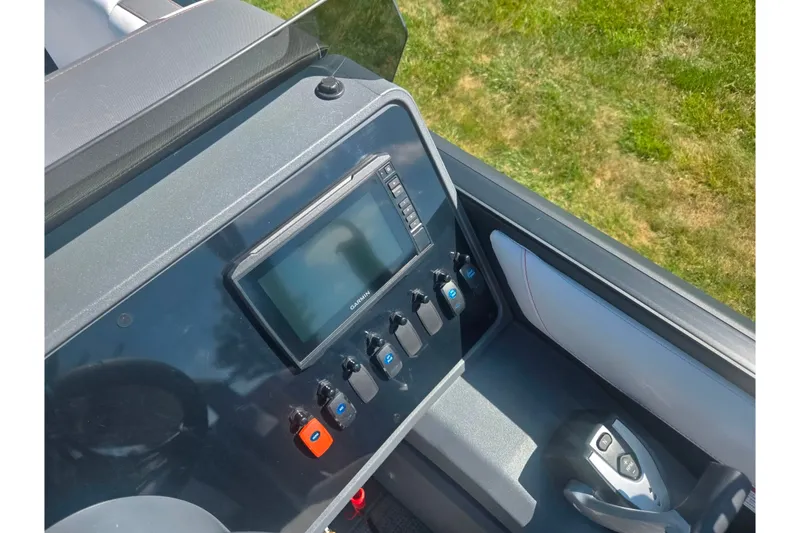 Slide: The Image of 2024 Manitou Cruise dashboard with Garmin display and control switches. - 21
