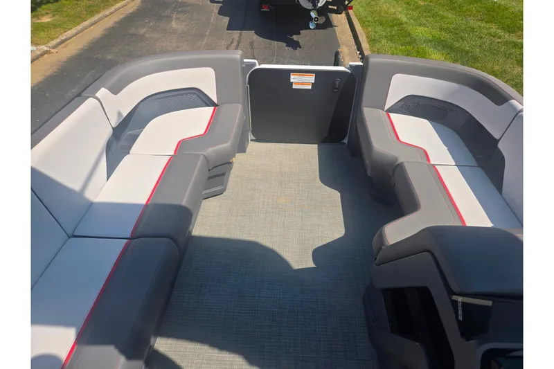 Slide: The Image of 2024 Manitou Cruise boat interior with gray and red seating, showcasing spacious design. - 22
