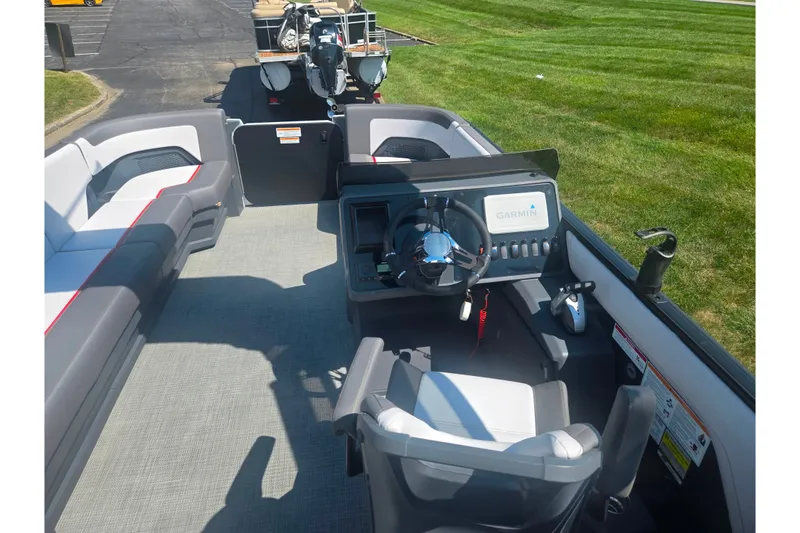 Slide: The Image of 2024 Manitou Cruise boat interior with Garmin navigation system and comfortable seating. - 19