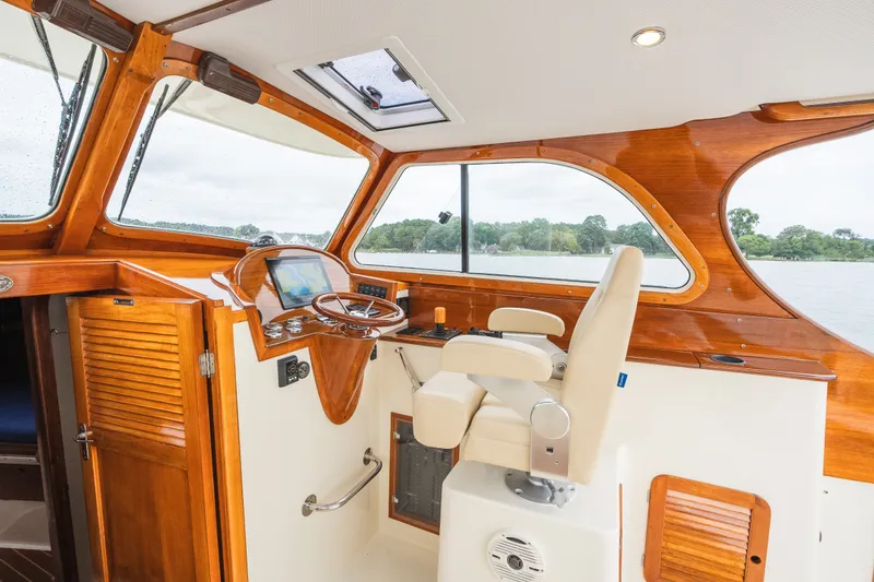 Slide: The Image of Interior of 2000 Hinckley Picnic Boat 36 Classic with wooden helm and modern controls. - 29
