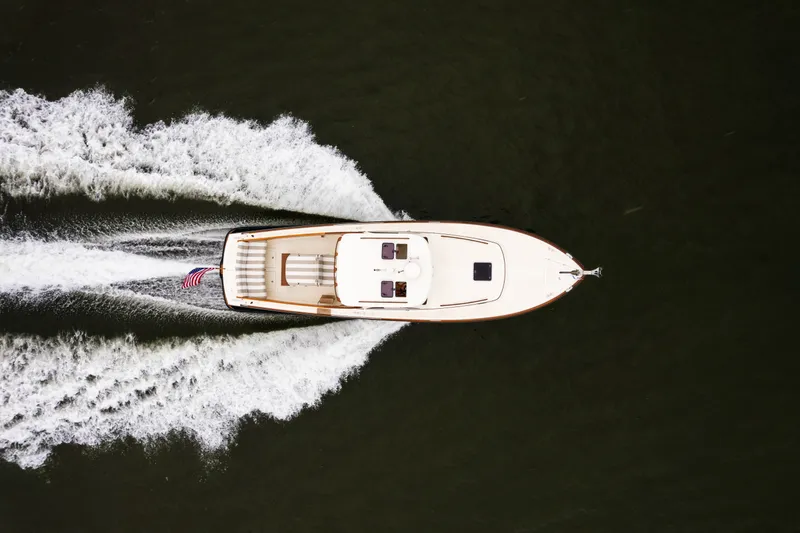 Slide: The Image of Top view of 2000 Hinckley Picnic Boat 36 Classic cruising on water. - 9
