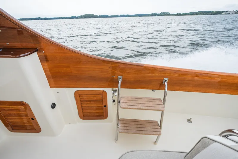 Slide: The Image of Hinckley Picnic Boat 36 Classic, 2000 model, featuring elegant wooden details and a serene water backdrop. - 39