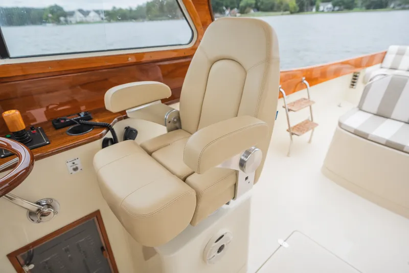 Slide: The Image of Helm seat of 2000 Hinckley Picnic Boat 36 Classic with luxurious beige upholstery. - 38