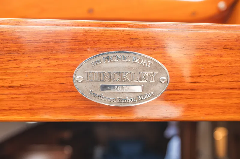 Slide: The Image of Hinckley Picnic Boat 36 Classic 2000 nameplate, Southwest Harbor, Maine, on polished wood surface. - 37
