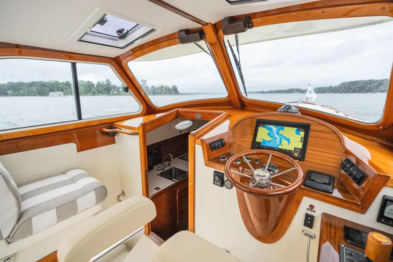 Slide: The Image of Interior of 2000 Hinckley Picnic Boat 36 Classic with wooden helm and navigation screen. - 32