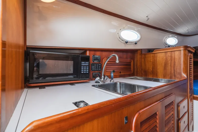 Slide: The Image of Hinckley Picnic Boat 36 Classic 2000 interior kitchen with microwave and sink. - 49