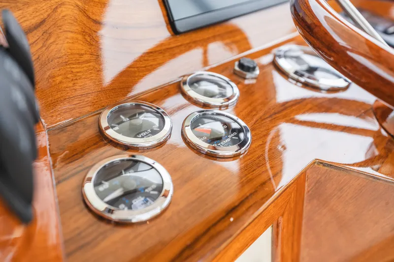 Slide: The Image of Close-up of 2000 Hinckley Picnic Boat 36 Classic dashboard with wooden finish and gauges. - 36