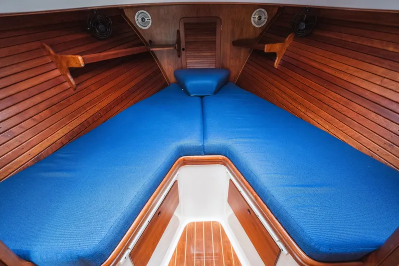 Slide: The Image of Hinckley Picnic Boat 36 Classic 2000 interior with blue cushions and wooden paneling. - 53