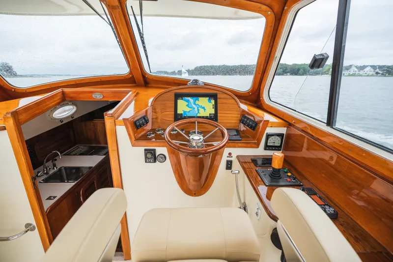 Slide: The Image of Interior of 2000 Hinckley Picnic Boat 36 Classic with wooden helm and navigation system. - 31