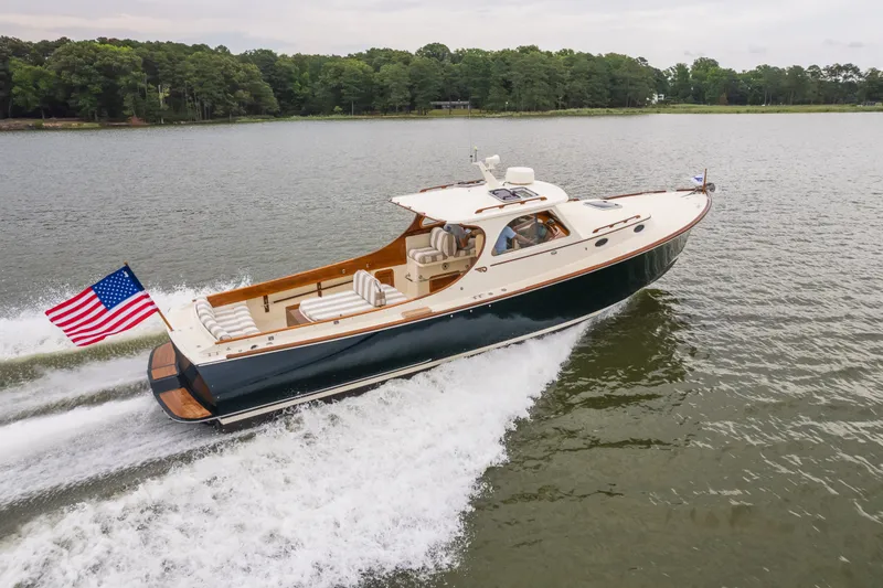 Slide: The Image of Hinckley Picnic Boat 36 Classic 2000 cruising on a lake with American flag. - 16