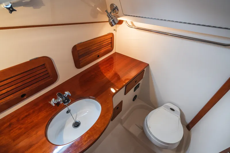 Slide: The Image of Hinckley Picnic Boat 36 Classic 2000 bathroom with wooden cabinetry and modern fixtures. - 57