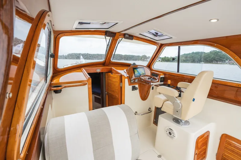 Slide: The Image of Interior of 2000 Hinckley Picnic Boat 36 Classic with elegant wood finish and helm station. - 27