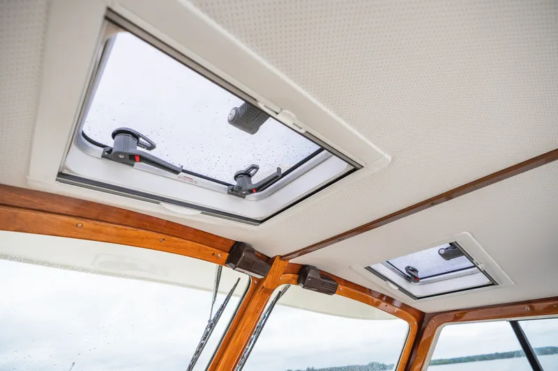 Slide: The Image of Hinckley Picnic Boat 36 Classic 2000 interior ceiling with skylights and wooden trim. - 44