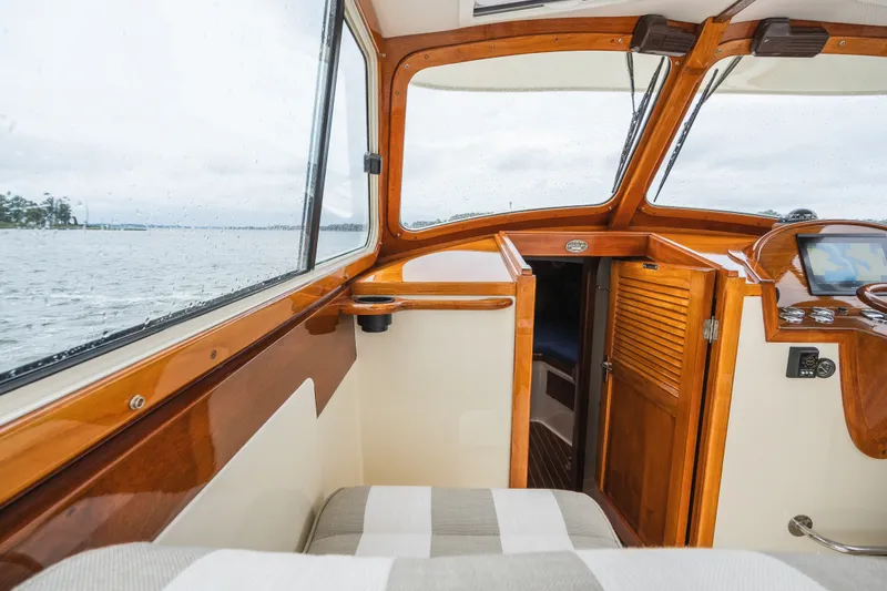 Slide: The Image of Interior of 2000 Hinckley Picnic Boat 36 Classic with wooden finish and water view. - 28