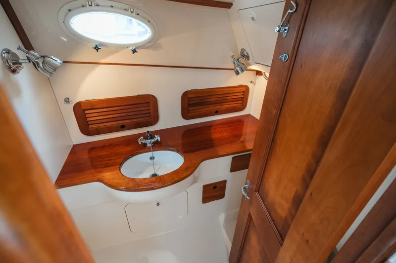 Slide: The Image of Hinckley Picnic Boat 36 Classic 2000 interior with wooden cabinetry and sink. - 59