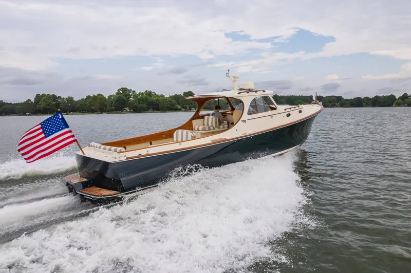Slide: The Image of Hinckley Picnic Boat 36 Classic 2000 cruising on a lake with American flag. - 2
