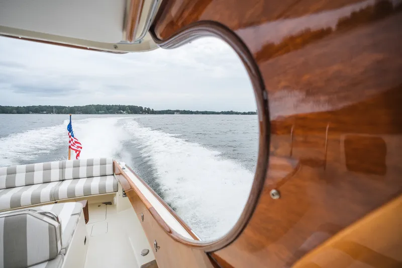 Slide: The Image of Hinckley Picnic Boat 36 Classic cruising on a lake, view from cabin window. - 3