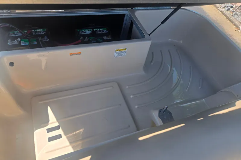 Slide: The Image of Interior view of a 2012 Manitou 25 Legacy boat compartment with battery storage. - 17