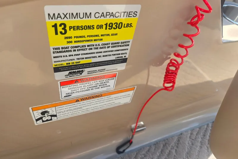 Slide: The Image of Capacity warning label on 2012 Manitou 25 Legacy boat, 13 persons or 1930 lbs. - 15
