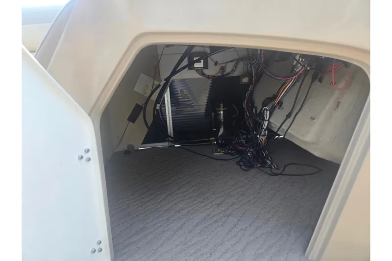 Slide: The Image of Interior view of a 2012 Manitou 25 Legacy boat compartment with wiring. - 12