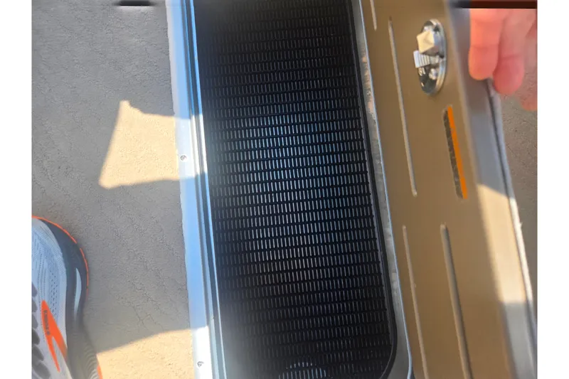 Slide: The Image of Open storage compartment on 2012 Manitou 25 Legacy boat, showing interior details. - 25