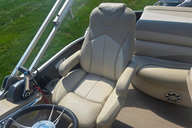 Slide: The Image of Luxurious seating on 2012 Manitou 25 Legacy boat, featuring beige leather upholstery. - 14