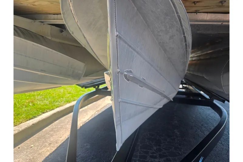 Slide: The Image of Underneath view of a 2012 Manitou 25 Legacy pontoon boat on a trailer. - 7
