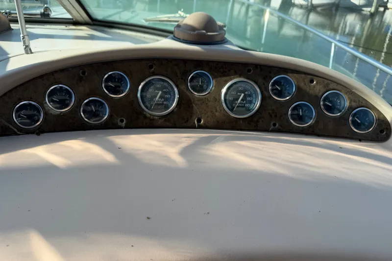 Slide: The Image of Dashboard of a 2002 Sea Ray 340 Sundancer boat with multiple gauges. - 23