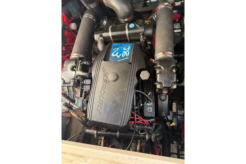 Slide: The Image of Engine of a 2002 Sea Ray 340 Sundancer boat, featuring Mercury components. - 18