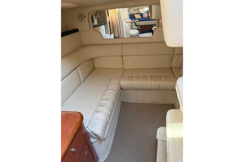 Slide: The Image of Interior of 2002 Sea Ray 340 Sundancer with beige seating and wooden cabinetry. - 15