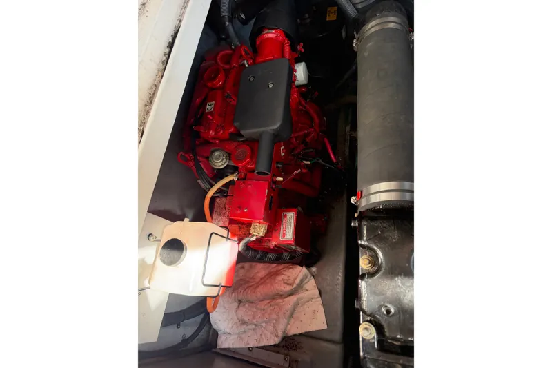 Slide: The Image of Engine compartment of a 2002 Sea Ray 340 Sundancer boat, featuring a red engine. - 22