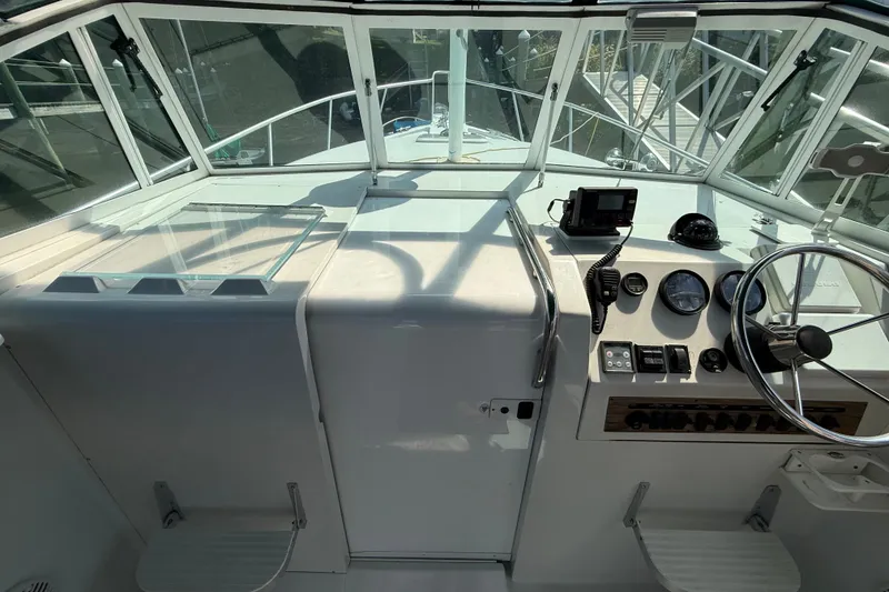 Slide: The Image of Cockpit of 2000 Mainship Pilot 30 with steering wheel and navigation instruments. - 14