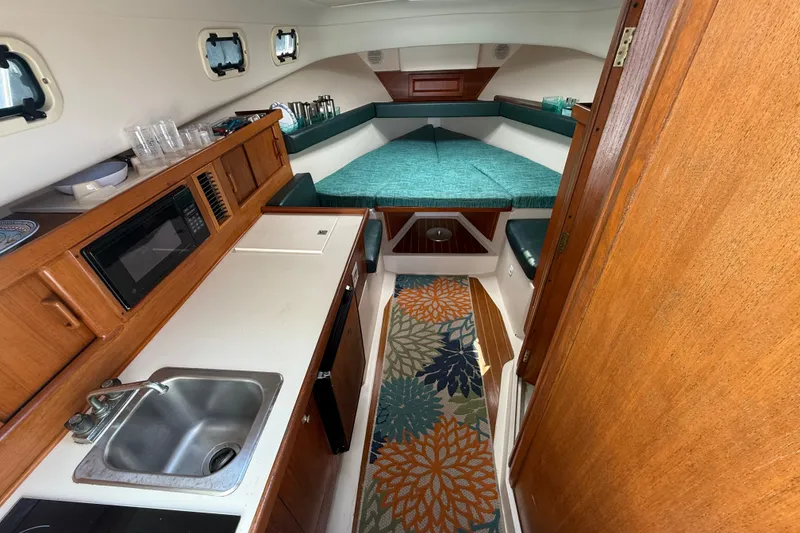 Slide: The Image of Interior of 2000 Mainship Pilot 30 boat with kitchenette and sleeping area. - 21