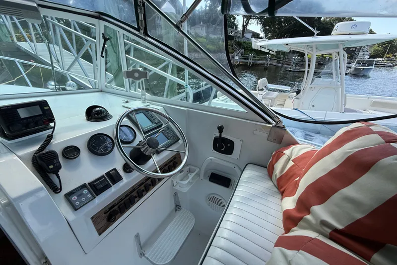 Slide: The Image of Interior view of 2000 Mainship Pilot 30 boat cockpit with steering wheel and controls. - 17