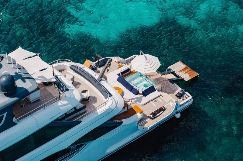 Slide: The Image of Luxurious 2023 Benetti Oasis 34 yacht with sun deck and turquoise sea backdrop. - 4