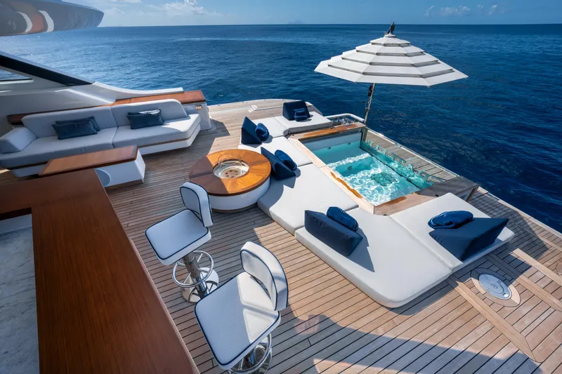 Slide: The Image of Luxurious Benetti Oasis 34 yacht deck with jacuzzi, lounge chairs, and ocean view, 2023 model. - 9