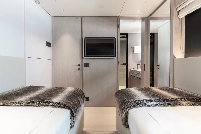 Slide: The Image of Luxurious interior of 2023 Benetti Oasis 34 yacht with twin beds and modern decor. - 25