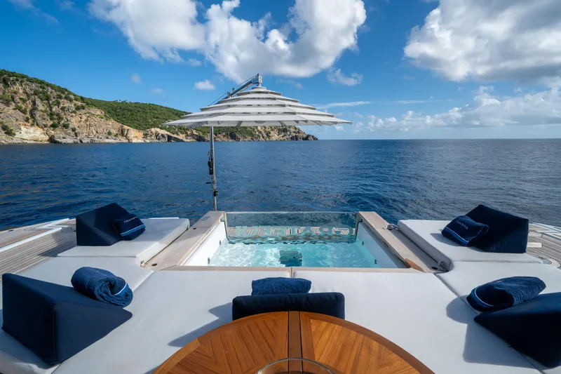 Slide: The Image of Luxurious Benetti Oasis 34 yacht deck with jacuzzi, ocean view, and sun loungers, 2023 model. - 8