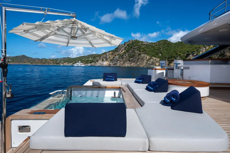 Slide: The Image of Luxurious Benetti Oasis 34 yacht deck with sun loungers and ocean view, 2023 model. - 10