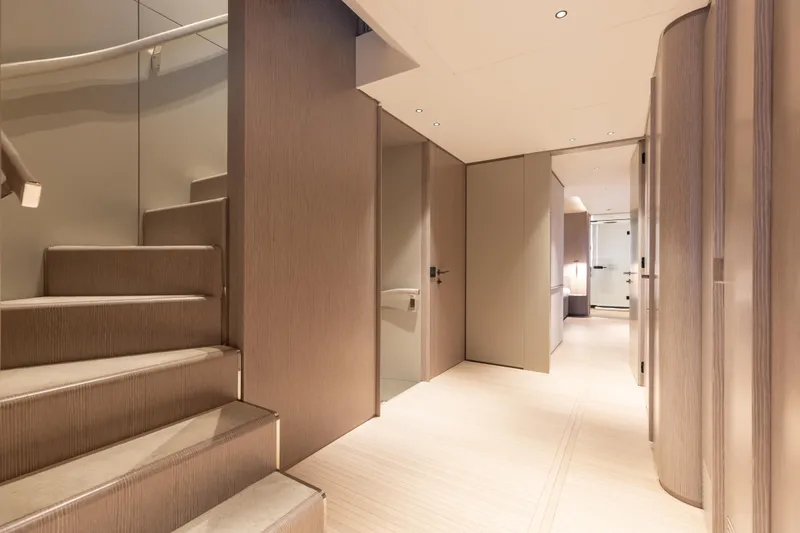 Slide: The Image of Interior of 2023 Benetti Oasis 34 yacht, featuring modern wood paneling and elegant design. - 16
