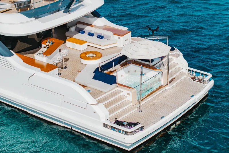 Slide: The Image of Luxurious 2023 Benetti Oasis 34 yacht with jacuzzi and bar on deck, cruising in blue waters. - 7