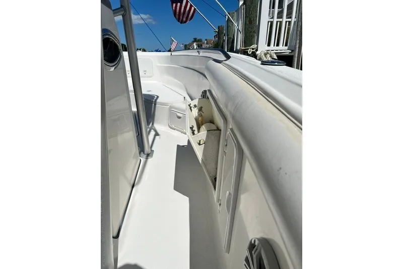 Slide: The Image of 2004 Wellcraft 252 Fisherman boat interior with storage compartments and American flag. - 11