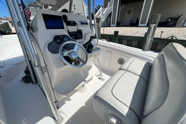 Slide: The Image of 2004 Wellcraft 252 Fisherman boat interior with steering console and seating. - 4