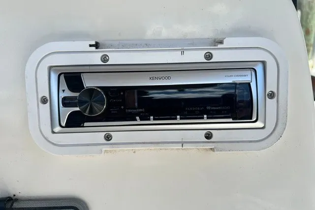 Slide: The Image of Kenwood stereo system installed on a 2004 Wellcraft 252 Fisherman boat dashboard. - 7