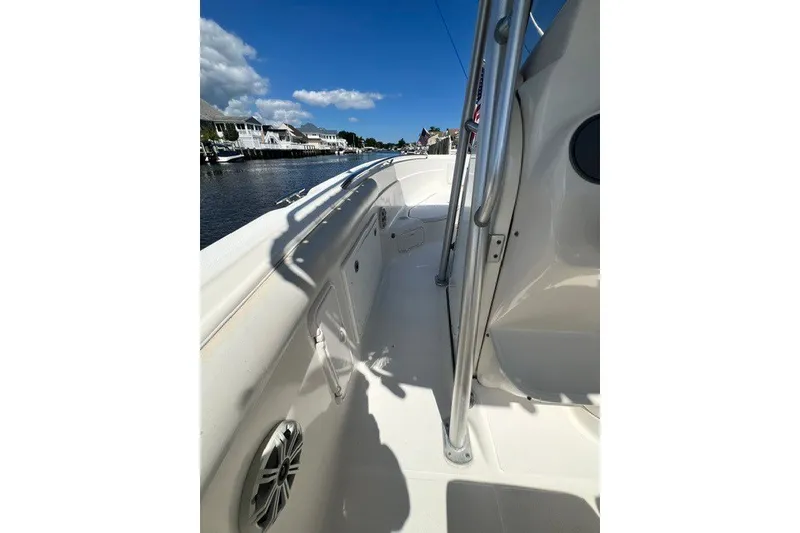 Slide: The Image of 2004 Wellcraft 252 Fisherman boat deck, sunny day, waterfront view. - 13