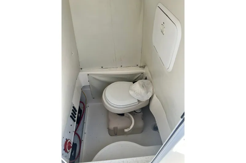 Slide: The Image of 2004 Wellcraft 252 Fisherman boat interior with compact marine toilet. - 16