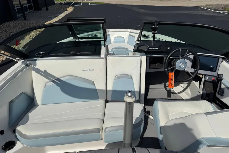 Slide: The Image of 2023 MasterCraft ProStar boat interior with steering wheel and seating. - 11